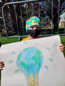 Climate Activist John with his protest sign 'A melting globe'